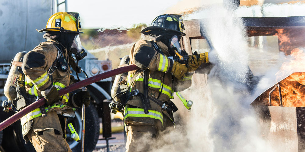 Two firefighters battling a fire. Photo Credit Matt C