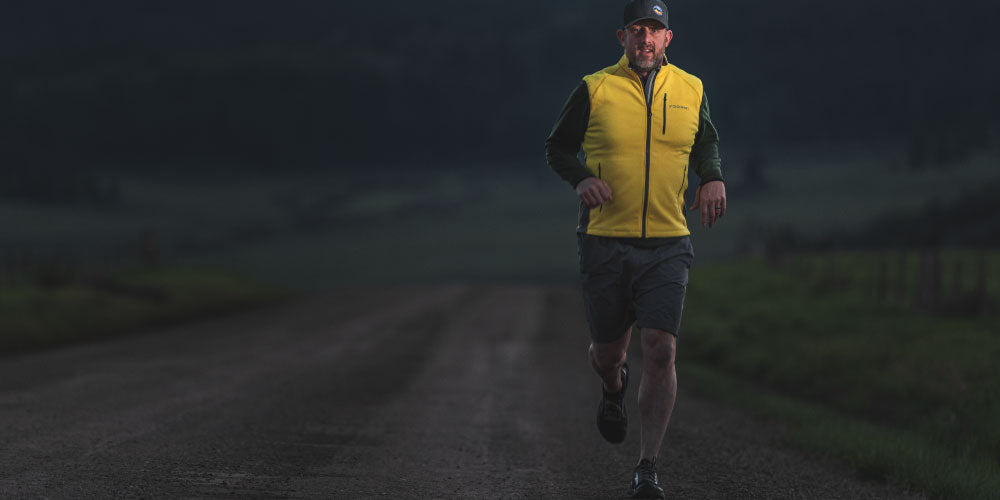 Man running in yellow vest not ignoring his thermal stress