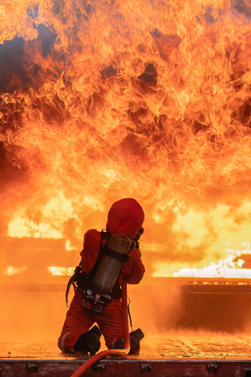 Fire fighter fighting fire with big flames