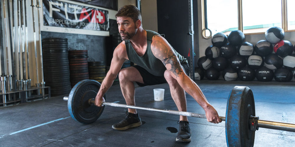Man lifting heavy barbell with weight
